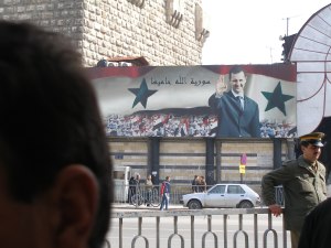 Unintended irony in the caption beside Bashar: 'God is Syria's Protector'